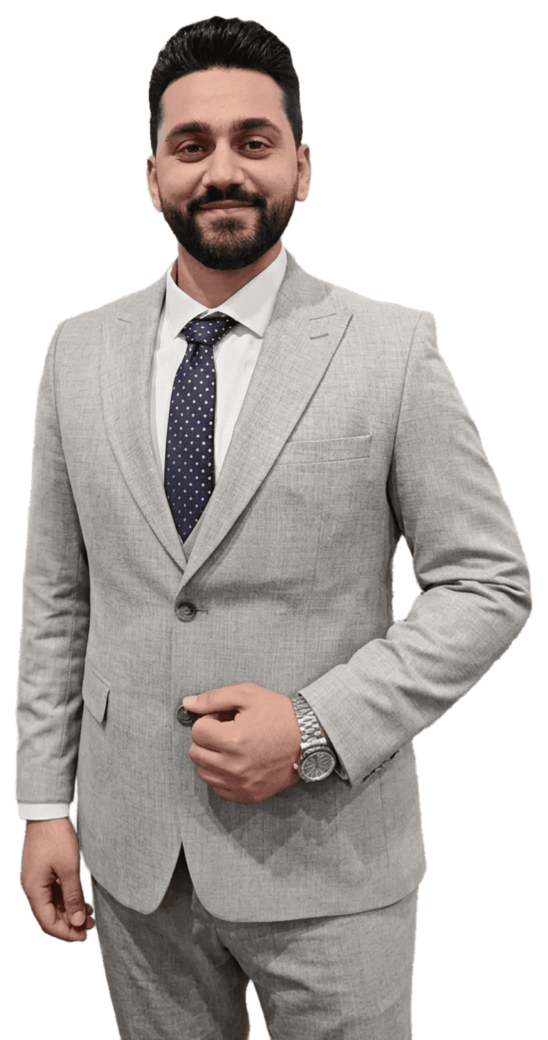 Nour Samman in a grey suit and navy tie, smiling